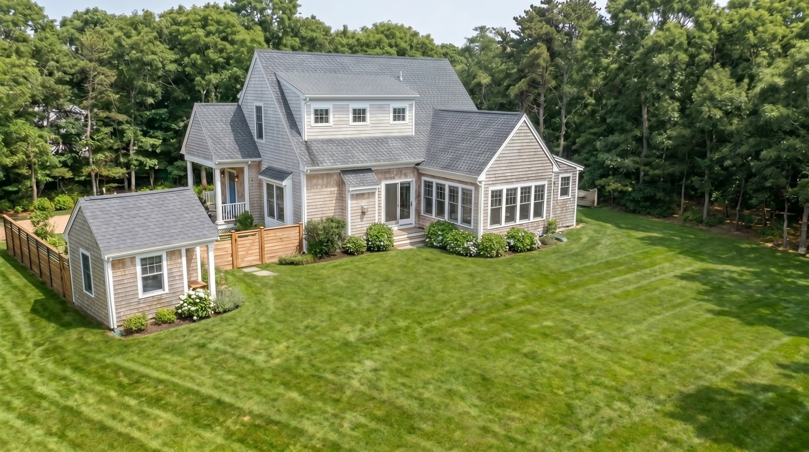 Before: shingled home with open lawn