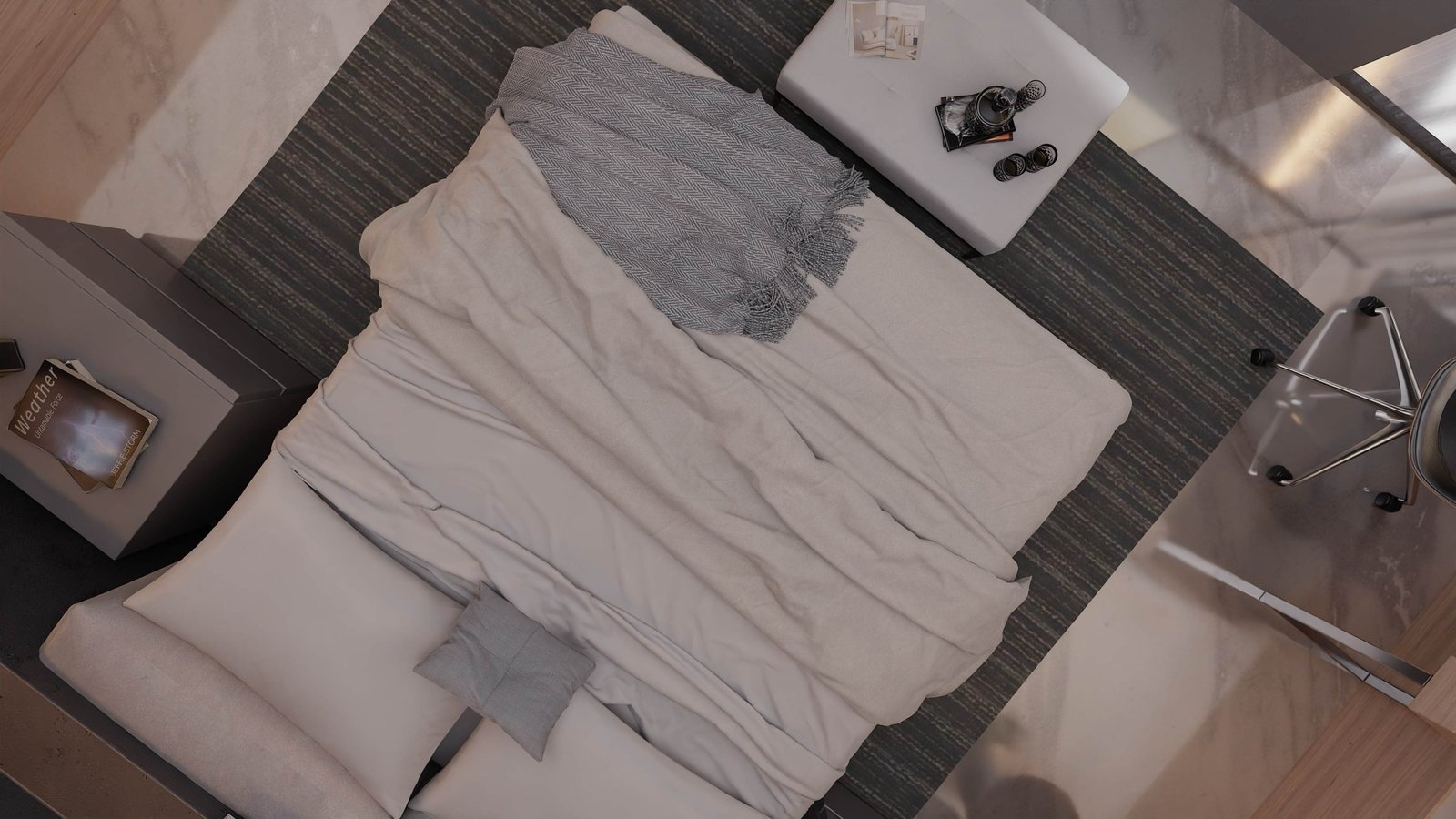Overhead view of a bed with layered linen bedding and a grey throw